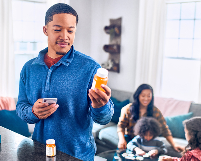 man looking at prescription bottle