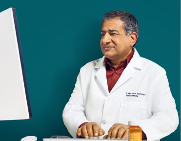 A pharmacist works on a computer